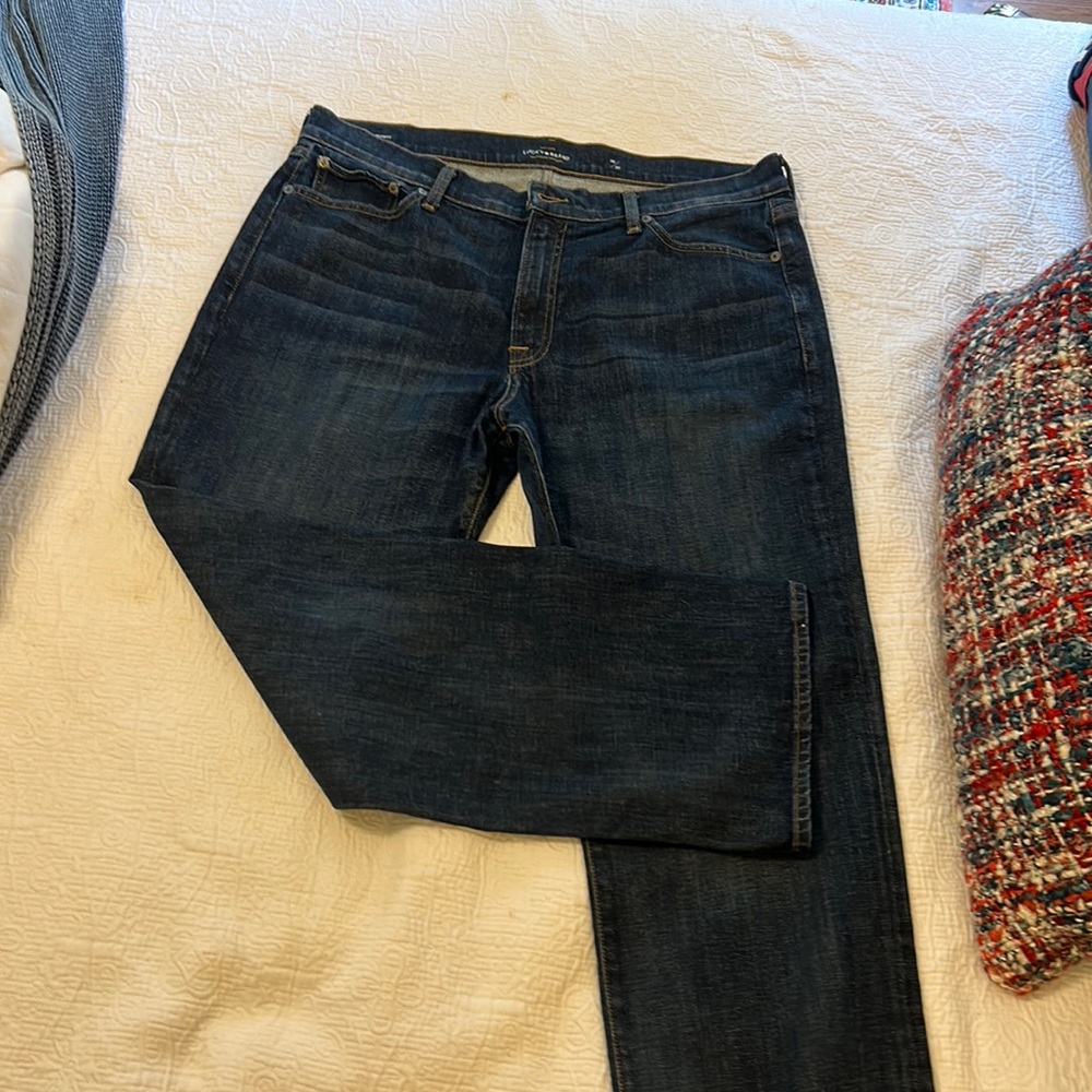 Men’s Lucky 361 vintage straight jeans is medium blue with slight distress. EUC